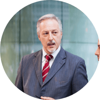 Man in a dark suit speaking in an office